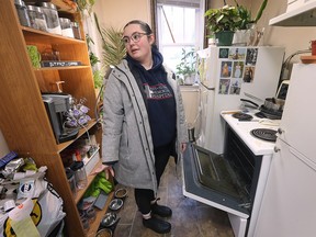 Ashlee Baker-Pinheiro is shown at her apartment in the Dieppe Park Apartment complex in downtown Windsor on Thursday, February 9, 2023. She has not had heat in her building for more than a year. She uses her stove to warm up the unit.