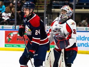 Windsor Spitfires' goalie Joey Costanzo tracks the puck as Saginaw Spirit forward Matyas Sopovoliv attempts to screen him during Saturday's game at the Dow Event Center. (Natalie Shaver/OHL Images)