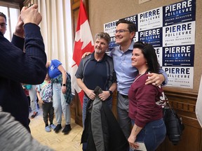 A couple poses for a photo with Pierre Poilievre, leader of the Conservative Party of Canada at a rally at the Caboto Club in Windsor on Saturday, February 11, 2023.