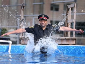 Windsor Police Insp. Ed Armstrong hits the frigid water on February 24, 2023 for the annual the Polar Plunge 2023 - Windsor-Essex fundraising event.
