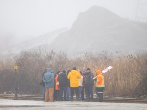 Employees at Windsor Salt, who have been on strike since last Friday, are seen on the rail line where they prevented a train from entering the Windsor Salt facility, on Thursday, Feb. 23, 2023.