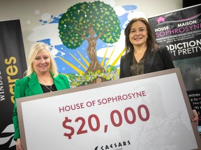 Susanne Tomkins, from Caesars Windsor, presents Karen Waddell, CEO of House of Sophrosyne, with a cheque for $20,000, on Tuesday, Feb. 28, 2023.