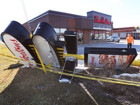 The toppled sign of a Tim Hortons location at 380 Maidstone Ave. West in the Town of Essex during windy conditions on Feb. 15, 2023.