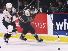Windsor Spitfires' centre Jacob Maillet, right, chases down a loose puck while Owen Sound's Sam Sedley tries to chase him down during Sunday's game at the WFCU Centre.