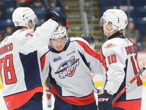 Alex Christopoulos, centre, is congratulated by teammates Roddy Dionicio, left, and Daniil Sobolev, right, after scoring against the Guelph Storm. Christopoulos and Sobolev are both overage candidates for the club in 2023-24.