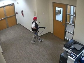 This handout video grab image courtesy of the Metropolitan Nashville Police Department released on Monday, March 27, 2023, shows suspect Audrey Hale holding an assault rifle at the Covenant School building at the Covenant Presbyterian Church, in Nashville, Tennessee.