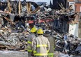 Aylmer firefighters remained at the scene on the morning of Tuesday March 21, 2023, about 12 hours after destroyed a building on Talbot Street downtown. (Derek Ruttan/The London Free Press)