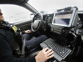 An OPP officer demonstrates the Automatic Licence Plate Recognition system in his cruiser.