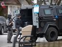 Members of the Windsor police tactical unit are seen positioned behind an armoured vehicle as they call for a person to exit a home in the 1000 block of Lincoln Road on Thursday, March 16, 2023.