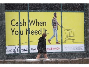 A pedestrian walks past the Cash Money loans service business in downtown Windsor on Monday, March 13, 2023.