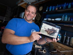 LaSalle-based expert diver Matt Zuidema shows a computer model of the Prohibition-era truck he documented at the bottom of the Detroit River for National Geographic. Photographed March 22, 2023.