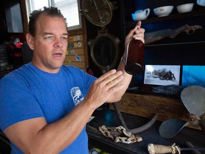 LaSalle-based expert diver Matt Zuidema shows items he has found in the Detroit River. Photographed March 22, 2023.