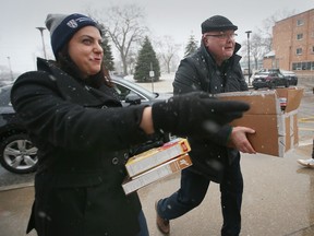 The University of Windsor Alumni Association hosted a Drive 'N' Drop, a campus and community food drive to benefit the Campus Food Pantry on Friday, March 3, 2023. Carole Obeid, an alumni board members greets a donor during the event.