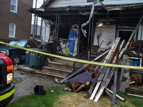 An investigator examines the scene of a house fire at 977 Pierre Ave. in Windsor on March 31, 2023.