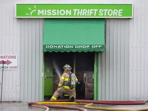 A firefighter directs water into a thrift store in the 300 block of Giles Boulevard in Windsor on March 29, 2023.
