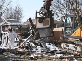 An investigator is shown at the scene of a house explosion in the 10000 block of Aspen Lane in Forest Glade, on Monday, March 20 2023.