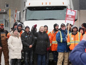 Unifor National President Lana Payne, centre (red gloves), joined inserting Windsor Salt workers and union supporters on Friday, March 3, 2023 while they blocked the exit of a semi-tractor trailer on the Windsor facility.
