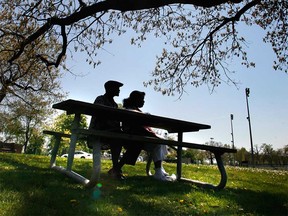 A couple takes refuge from the sun under a tree in Windsor's Mic Mac Park in this file photo.