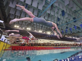 Athletes dive into the pool during finals at the OFSAA swimming championships at the Windsor International Aquatic Centre on Wednesday, March 1, 2023.