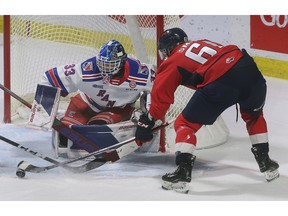 Windsor Spitfires' forward Colton Smith can't get a handle on the puck in front of Kitchener Rangers' goalie Marco Constantini during Thursday's game at the WFCU Centre.