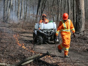A technician lights a section of the Ojibway Park during a prescribed burn on Tuesday, March 21, 2023.
