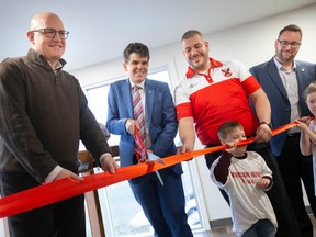 From left, Mayor Drew Dilkens, MPP Andrew Dowie, Windsor Rogues Rugby Club president, Scott Murphy, and councilor Mark McKenzie, help cut the ribbon to the club's new building at AKO Park, on Friday, March 31, 2023.