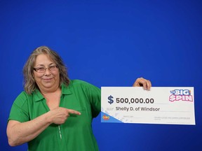 Shelly Desbien of Windsor holds her $500,000 prize cheque from playing The Big Spin. Photographed March 17, 2023.