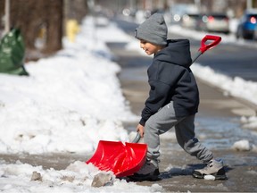 Ameer Ibrahim, 6, helps out with snow shovelling after a snow storm hit the region, on Saturday, March 4, 2023.  Above freezing temps and bright sunny skies are causing a lot of the snow to now melt.