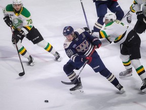 Windsor Spitfires' forward Alex Christopoulos fights off London Knights' forward Easton Cowen during Saturday's game at the WFCU Centre.