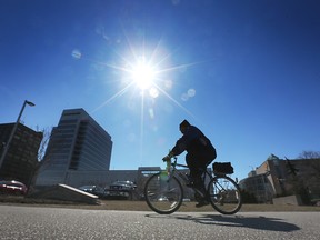 A cyclist enjoys a sunny Monday, March 20 2023, the first official day of Spring in downtown Windsor.