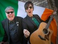 Kevin Shannon, left, holding the Irish flag, and Ted Lamont, also known as the rock duo, PaddyWhacked, are pictured on Wednesday, March 15, 2023.  The duo will be performing at the Kildare House and the Dominion House for St. Patrick's Day festivities.