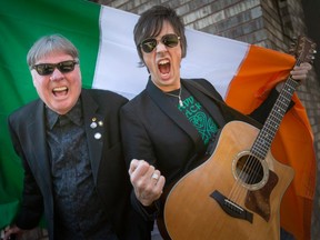 Kevin Shannon, left, holding the Irish flag, and Ted Lamont, also known as the rock duo, PaddyWhacked, are pictured on Wednesday, March 15, 2023.  The duo will be performing at the Kildare House and the Dominion House for St. Patrick's Day festivities.