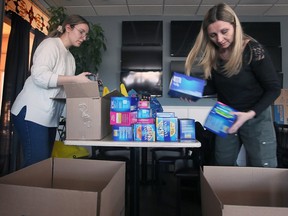 Katarina Kolobaric, left, and Jenny Sylvestre, volunteers with the Tampon Tuesday event sort donations at the Harbour House in Windsor on Tuesday, March 7, 2023. The event was sponsored by the United Way.