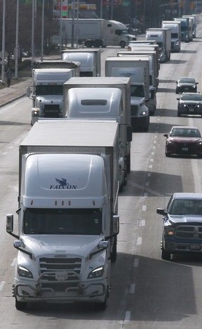 Commercial truck traffic is shown last Thursday on Huron Church Road. A company setting up a new local manufacturing facility specializes in high-tech cameras, monitors and AI driver training systems for the trucking industry.