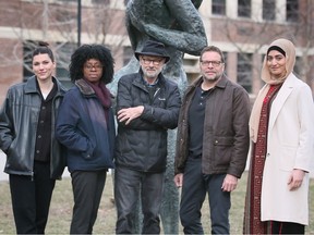 University of Windsor students Julia Sanders, Chidera Ikewibe, left, and Rawand Mustafa, right, are shown with professors Marty Gervais, third from left, and Andre Narbonne on Friday, March 24, 2023. The group collaborated on the publishing of an anthology book of poems on public art.