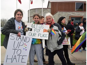 Denise Caskanette, left, with daughter Violet and mother Annette Zeyl, rallied outside Norwich Township's council building on Tuesday to protest a motion banning non-government flags, including Pride flags, on municipal property. They were also showing support for a separate motion to declare June as Pride month in the rural township. (Calvi Leon/The London Free Press)