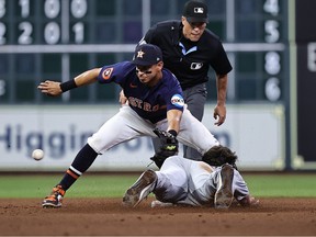 Matt Vierling #8 of the Detroit Tigers steals second base against Mauricio Dubon #14 of the Houston Astros in the second inning at Minute Maid Park on April 4, 2023 in Houston, Texas.