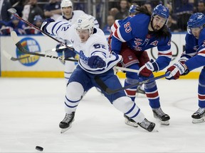 Maple Leafs' Noel Acciari (left) and Rangers' Mika Zibanejad vie for the puck during the first period on Thursday, April 13, 2023, in New York.