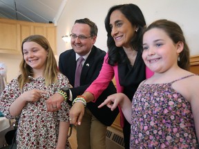Abigail Pitre, 10, and her sister Olivia Pitre, 8, pose with local MP Irek Kusmierczyk and Minister of National Defence Anita Anand at the Polish Club Windsor on Thursday, April 13, 2023. The youngsters gave the MPs bracelets they made to raise money to support Ukraine war victims.