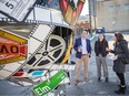 FedDev Ontario Minister Filomena Tassi, centre, is joined by Windsor-Tecumseh MP Irek Kusmierczyk and collaborating artist, Billie McLaughlin  as a new art installation is unveiled in WIFF Alley, on Monday, April 3, 2023.