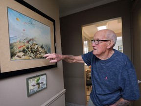 'So frickin' scared.' Korean War veteran Bernard Cote, 94, shows a Ted Zuber painting in his Windsor home on April 21, 2023. The war artist depicted the scene atop Hill 677 during the Battle of Kapyong at the location when Cote and his platoon mates helped hold off a vastly superior number of enemy troops.