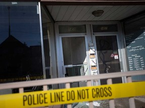 The entrance doors to 1657-1659 Drouillard Rd. in Windsor is blocked by police tape on April 14, 2023.