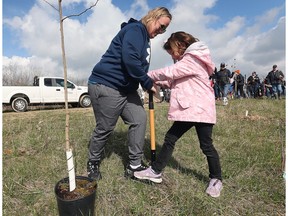 WINDSOR, ONT: APRIL 23, 2023. Jennifer Lucier and her daughter Emily, 7, are shown at the Essex Region Conservation Authority's Earth Day tree planting event in Windsor on Sunday, April 23, 2023. Hundreds of participants planted trees along the Little River corridor.