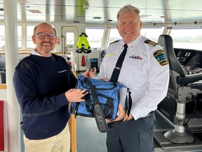Port Windsor Harbour Master Peter Berry, right, welcomes M/V Egbert Wagenborg Captain Francis Bos after the ship was the first "salty" at the port April 4.