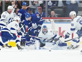 Maple Leafs center Calle Jarnkrok battles for the puck with Tampa Bay Lightning center Anthony Cirelli in front of goaltender Andrei Vasilevskiy during the second period in game five of the first round of the 2023 Stanley Cup Playoffs at Scotiabank Arena.