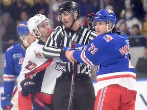 A linesman tries to separate Windsor Spitfires' defenceman Nicholas De Angelis, left, from Kitchener Rangers' captain Francesco Pinelli after his blindside hit on Windsor teammate Oliver Peer. Pinelli was given a five-minute major and game misconduct and was handed a three-game suspension on Wednesday by the OHL.