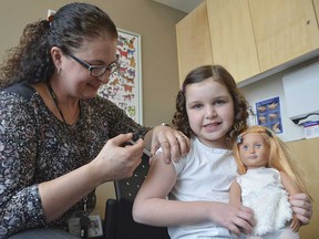 A child receives an immunization shot in Owen Sound in March 2019.