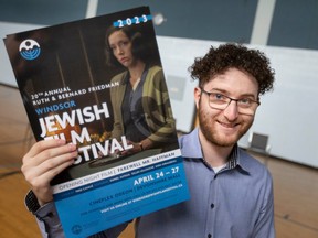 Joe Schnayer, head of programming and senior services at the Windsor Jewish Community Centre, holds posters for the upcoming Jewish Film Festival, on Tuesday, April 18, 2023.