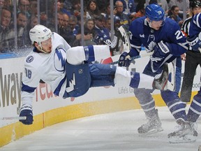 Mikhail Sergachev, left, of the Tampa Bay Lightning is taken into the boards by Sam Lafferty of the Toronto Maple Leafs during Game 1 of the First Round of the 2023 Stanley Cup Playoffs at Scotiabank Arena on April 18, 2023 in Toronto.