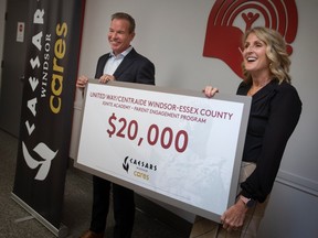 Kevin Laforet, president of Caesars Windsor, and Lorraine Goddard, CEO at United Way/Centraide Windsor-Essex County, display a cheque donation from Caesars Windsor Cares for $20,000 to support the Ignite Academy Parent Engagement Program, on Tuesday, April 4, 2023.